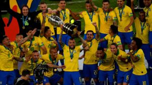 Elenco da Seleção com o troféu da Copa América 2019. Richarlison aparece no canto esquerdo da foto - Crédito: 
